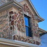 The Stones and bricks are too heavy, and not properly supported creating a sag and buckle which has made it pull away from the house.
