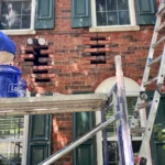 The repair process on a Red Brick House with several cracks in brick and mortar around windows and Arches - Lonestar Masonry Repair performs Brick and Mortar Repairs by removing and repairing and then matching brick and motar