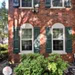 Red Brick House with several cracks in brick and mortar around windows and Arches - Lonestar Masonry Repair performs Brick and Mortar Repairs
